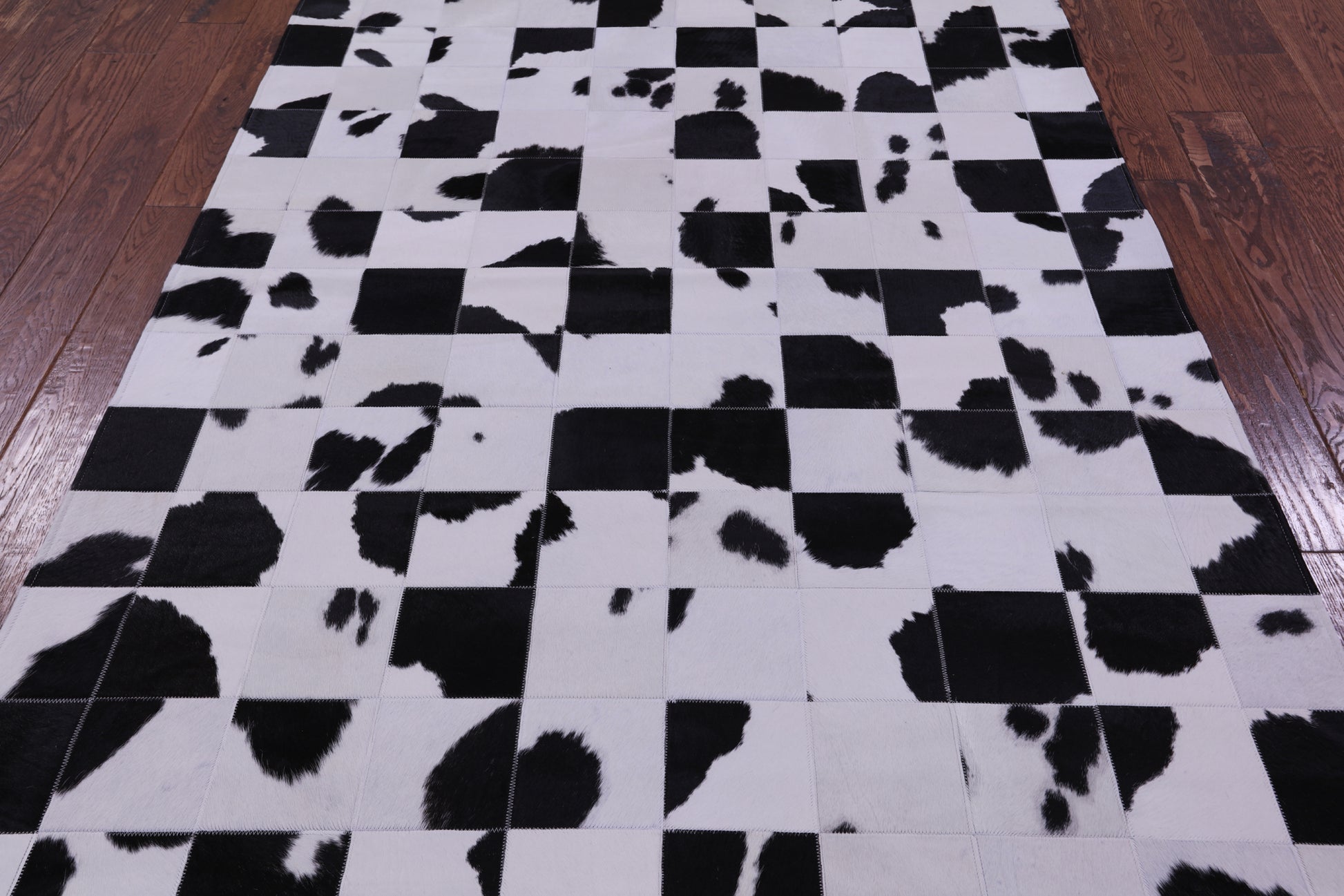 Black & White Natural Cowhide Hand Stitched Patchwork Rug - 4' 10" X 6' 9" - Golden Nile