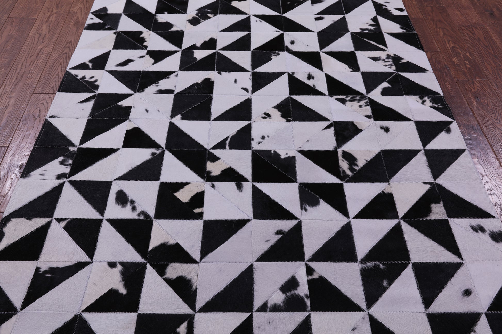 Black & White Natural Cowhide Hand Stitched Patchwork Rug - 4' 11" X 6' 10" - Golden Nile