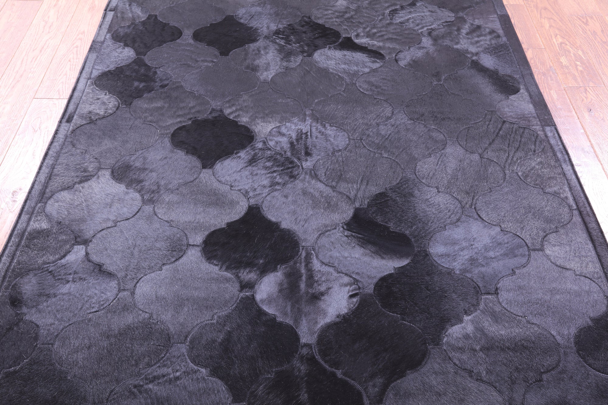 Lantern Tile Black Natural Cowhide Hand Stitched Patchwork Rug - 4' 10" X 6' 6" - Golden Nile