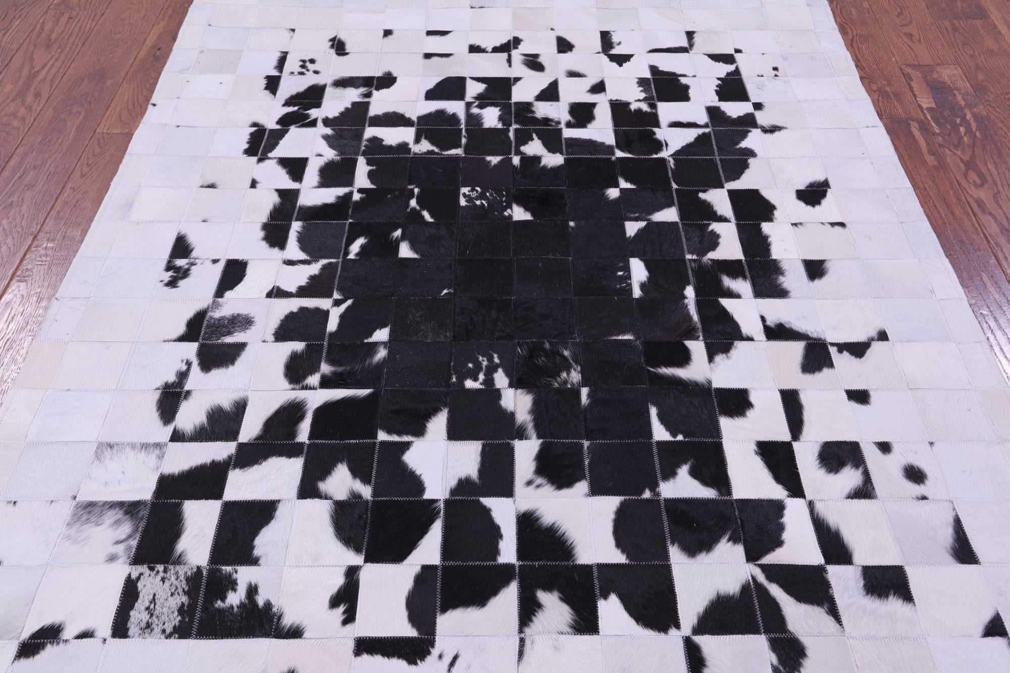 Black & White Natural Cowhide Hand Stitched Patchwork Rug - 5' 0" X 6' 7"