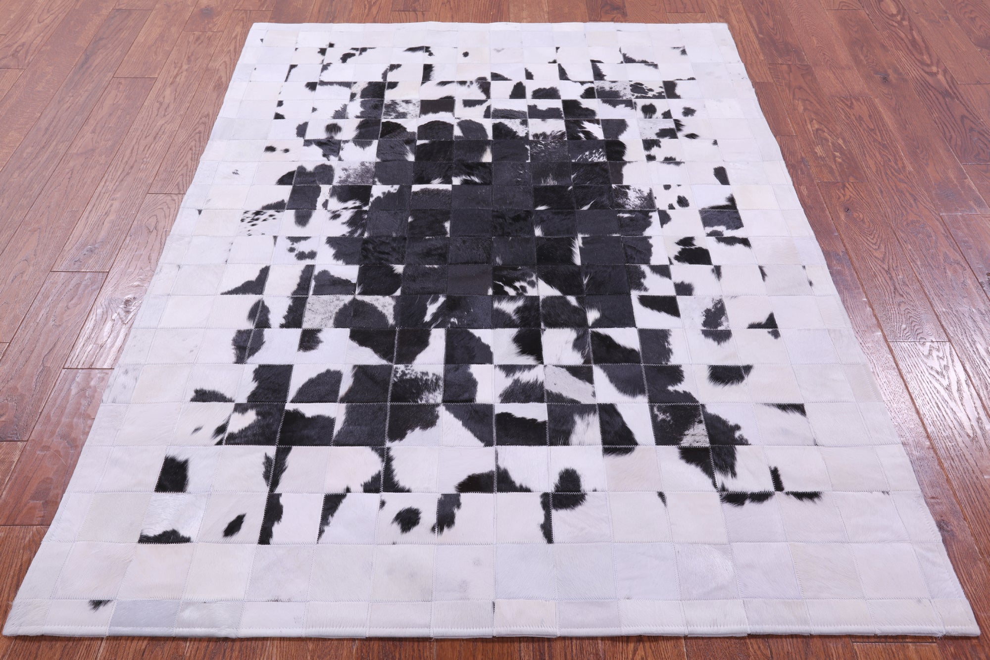 Black & White Natural Cowhide Hand Stitched Patchwork Rug - 5' 0" X 6' 7"