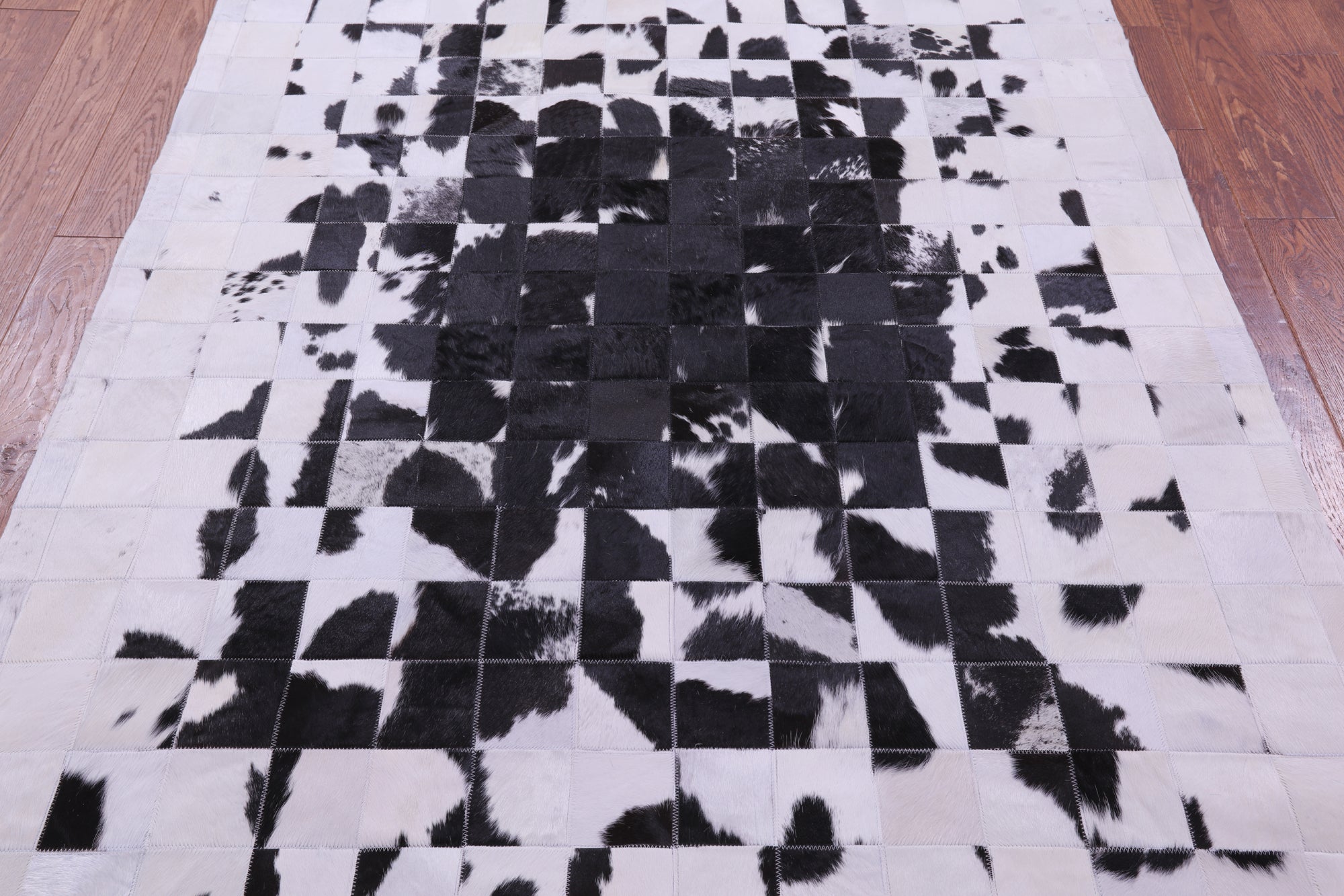 Black & White Natural Cowhide Hand Stitched Patchwork Rug - 5' 0" X 6' 7"