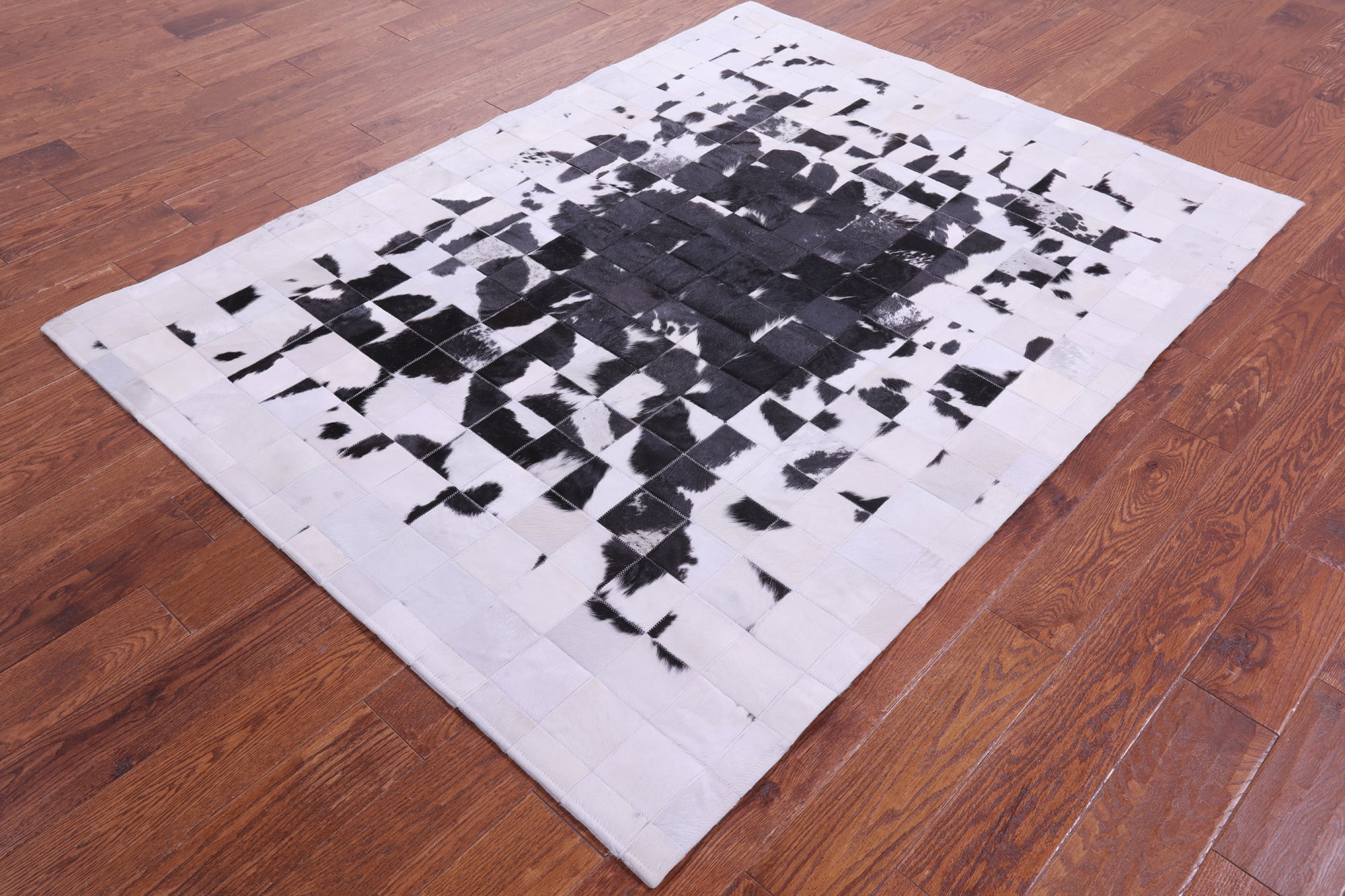 Black & White Natural Cowhide Hand Stitched Patchwork Rug - 5' 0" X 6' 7"