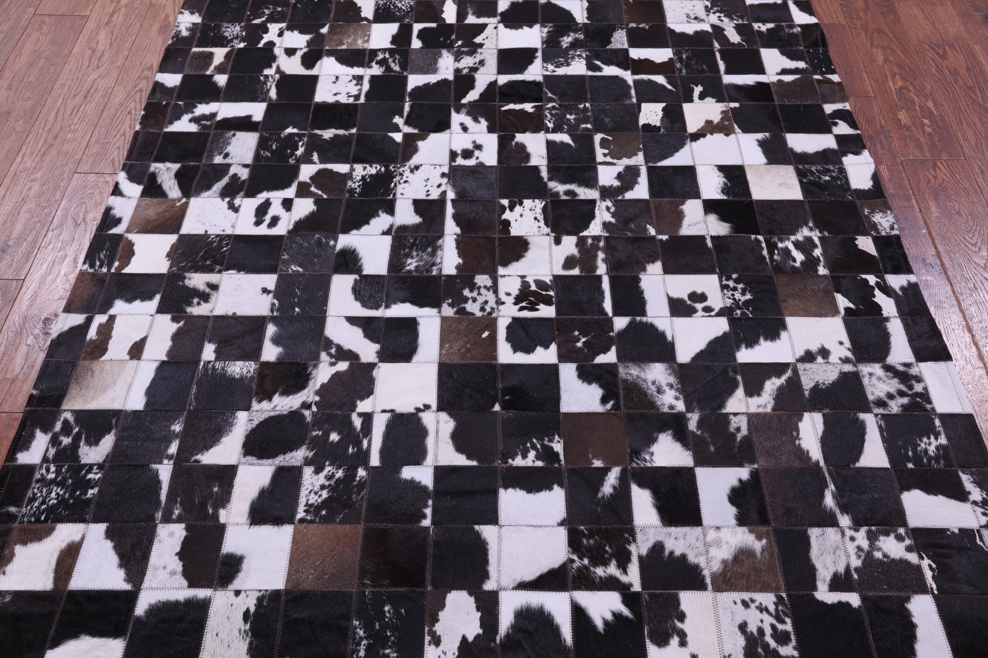 Brown & White Natural Cowhide Hand Stitched Patchwork Rug - 5' 0" X 6' 7"