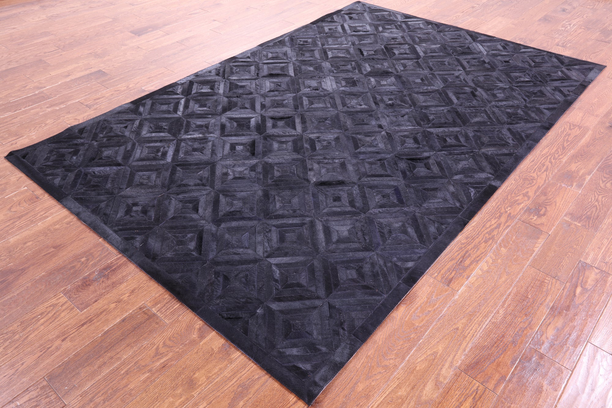 Black Natural Cowhide Hand Stitched Patchwork Rug - 6' 0" X 9' 0"
