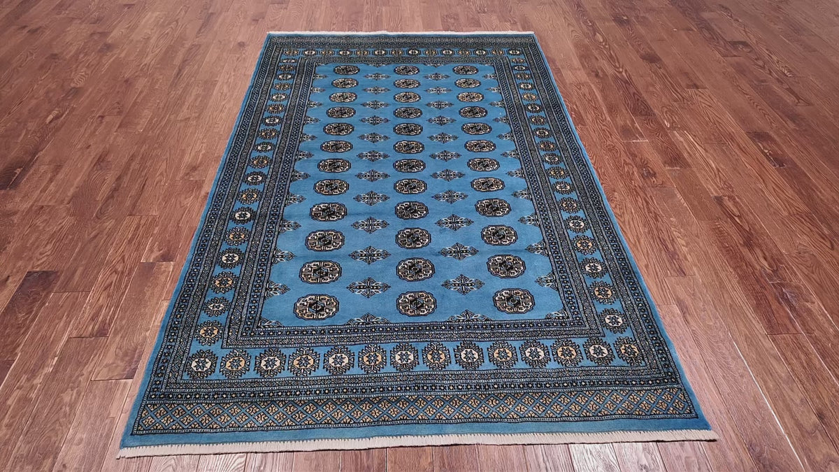 Load video: Blue Bokhara Handmade Wool Rug - 5' 6" X 8' 2"