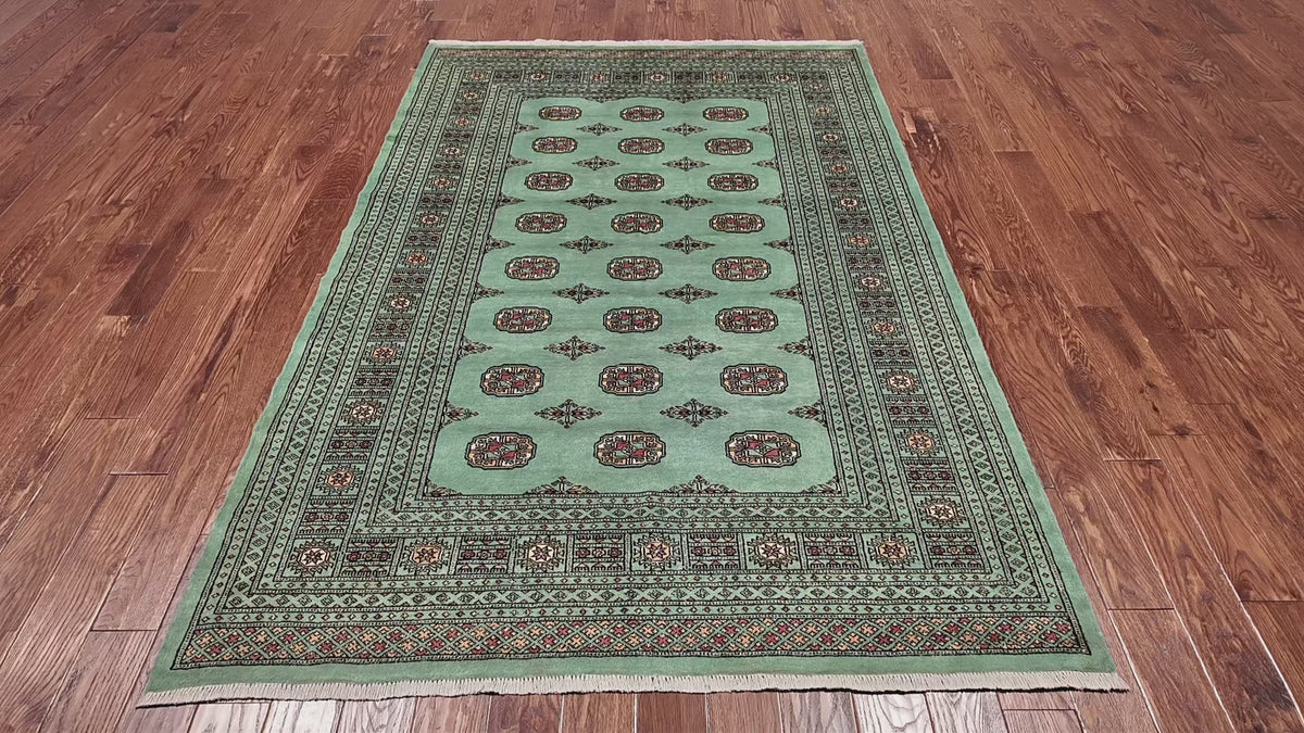 Load video: Green Bokhara Hand-Knotted Wool Rug - 5' 8" X 8' 1"
