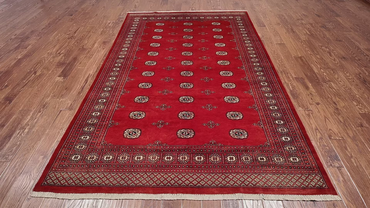 Load video: Rust Bokhara Hand-Knotted Wool Rug - 6' 6" X 10' 1"